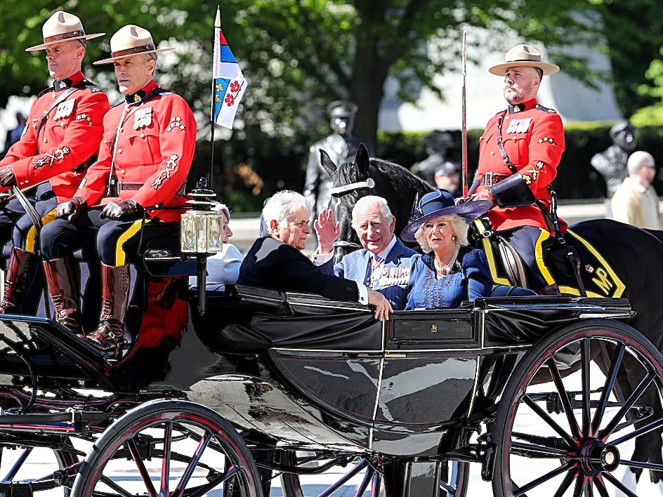 ਬਰਤਾਨਵੀ ਸਮਰਾਟ ਤੇ ਉਨ੍ਹਾਂ ਦੀ ਪਤਨੀ ਸ਼ਾਹੀ ਬੱਗੀ ਵਿਚ ਕੈਨੇਡੀਅਨ ਸੰਸਦ ਵਿਚ ਪਹੁੰਚਦੇ ਹੋਏ।